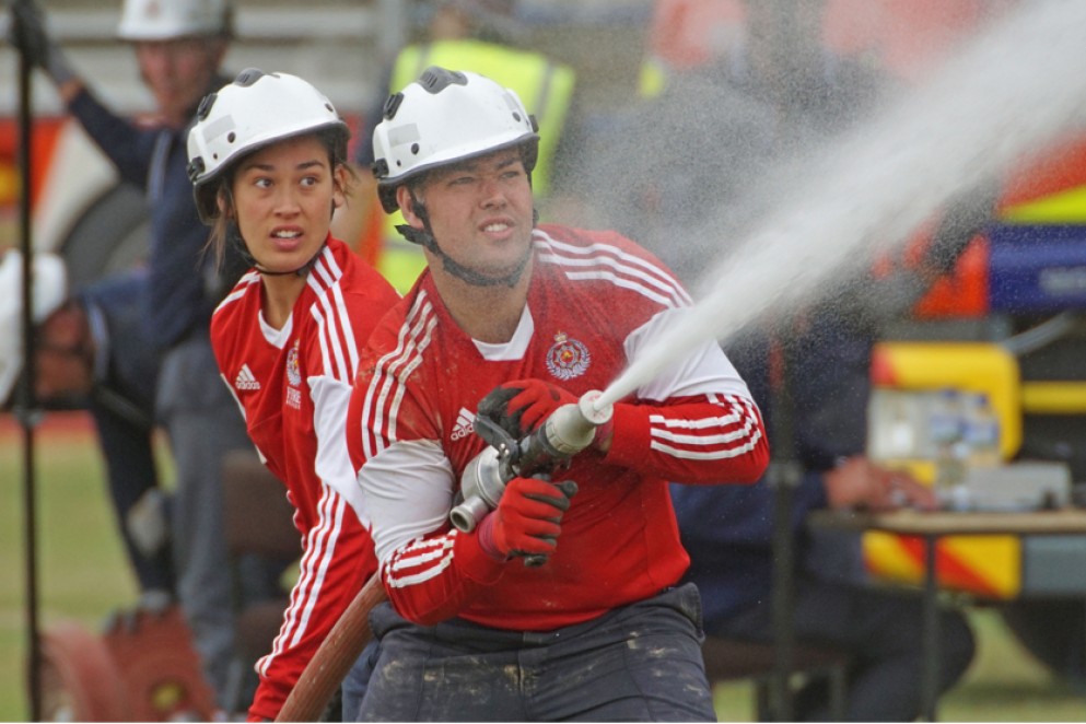 Two firefighters spraying firehose