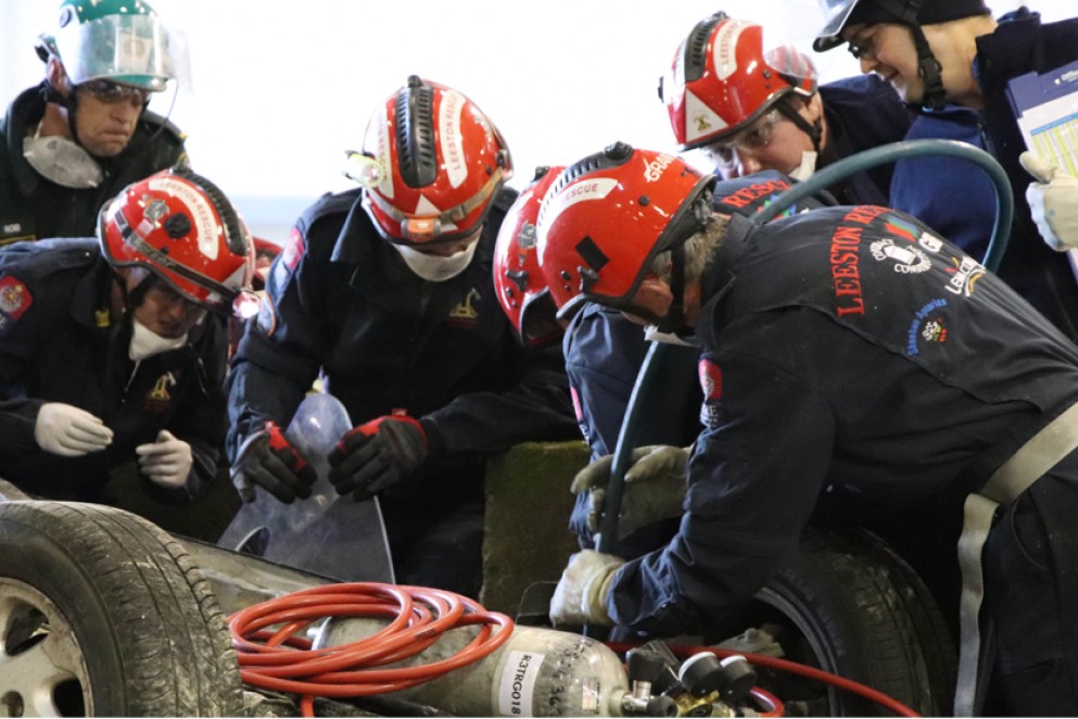 Firefighters attending to a simulated car crash 