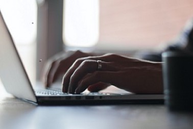 Photo of fingers tapping on laptop